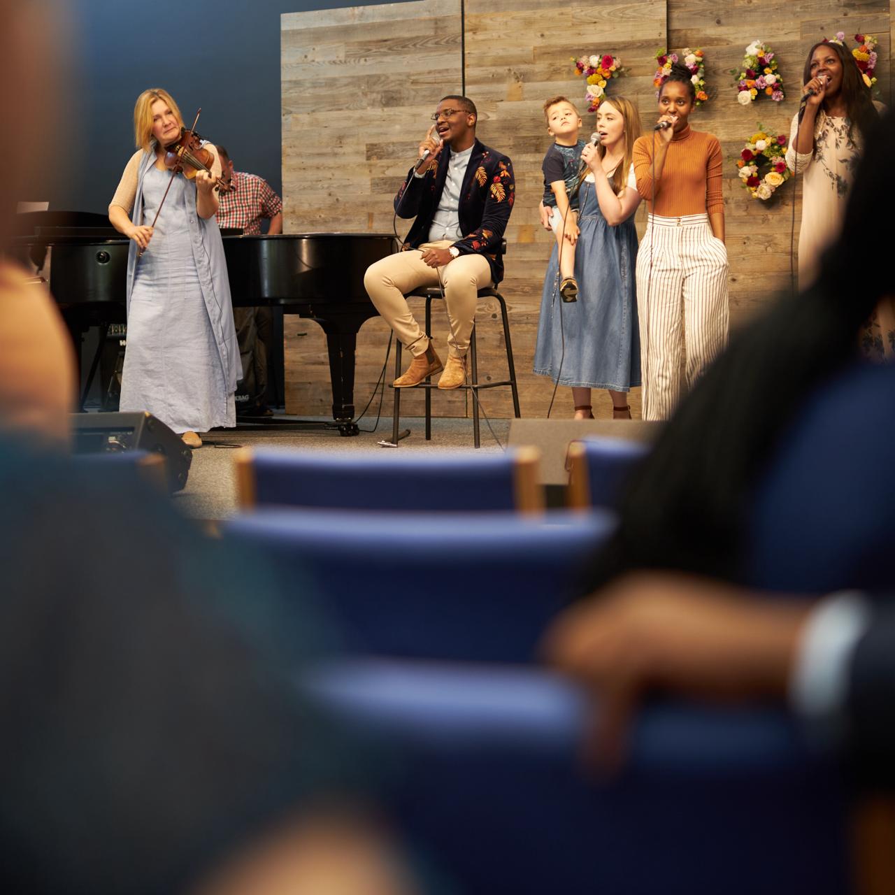 The Newbold Church worship team leading the congregation with violin and song